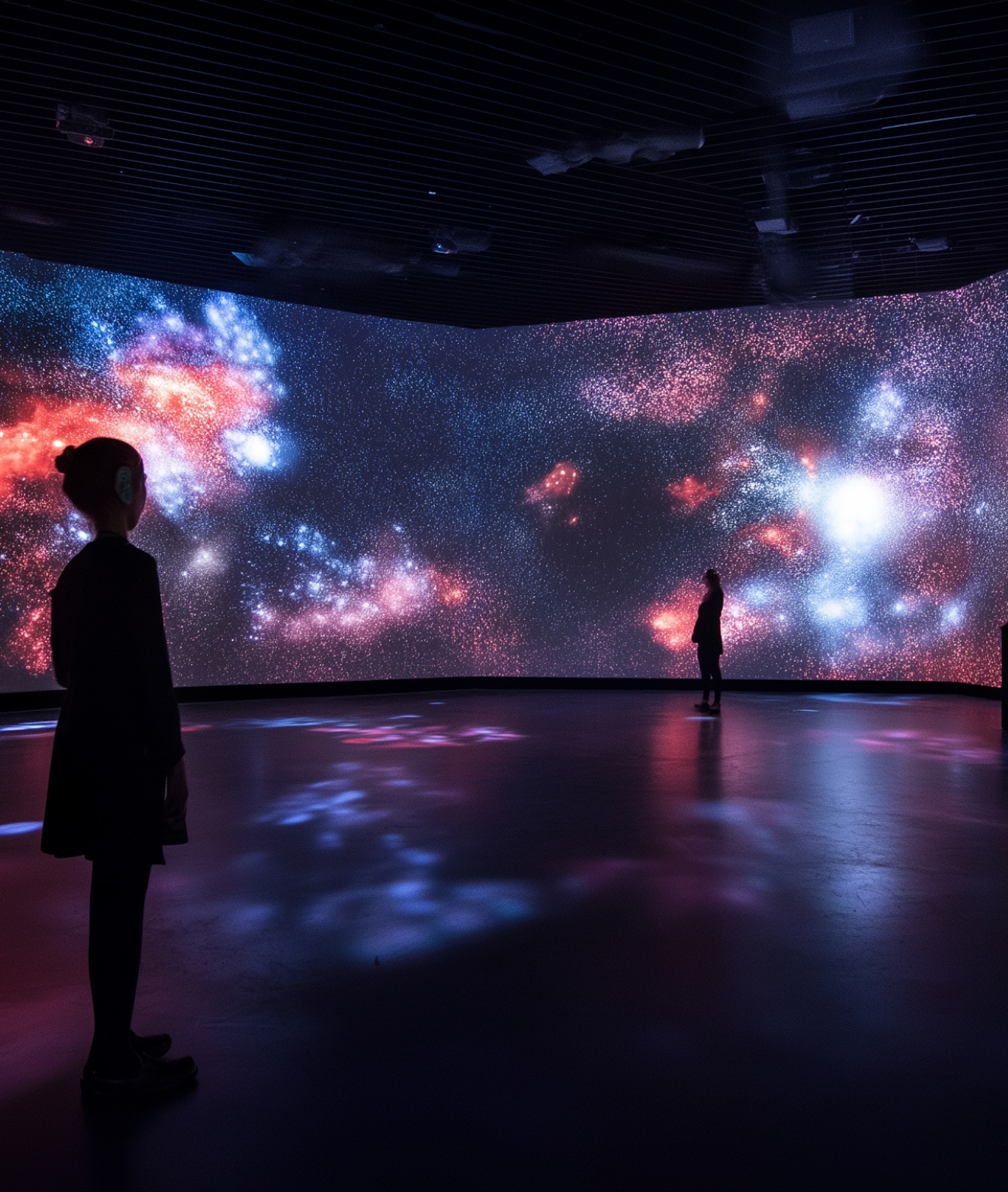 Students immersed in an interactive educational experience within a space featuring video mapping